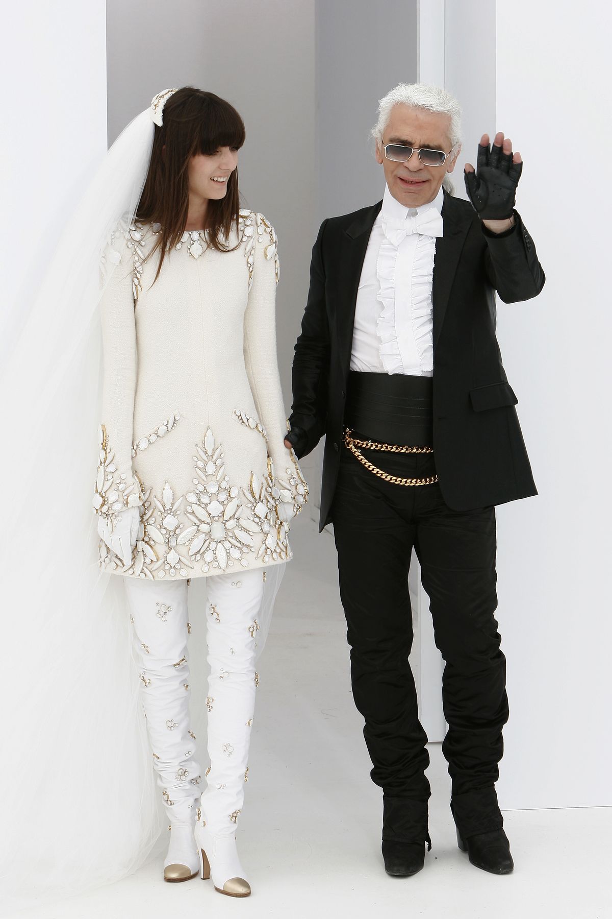 PARIS - JULY 6:  Destinger Karl Lagerfeld and one of his models are seen on the runway at the end of his Chanel Haute Couture Fall-Winter 2006/07 Fashion show during Paris Fashion Week at Pelouse de St Cloud on July 6, 2006 in Paris, France.  (Photo by Francois Durand/Getty Images)