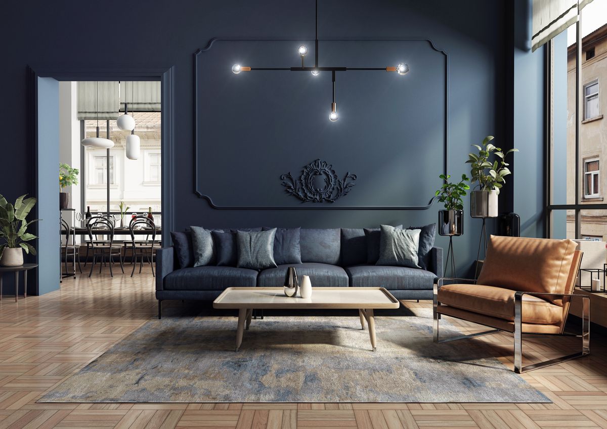 A modern and spacious apartment in an old tenement house. An elegant and blue living room with a comfortable sofa and armchair designed in a classic, vintage and mid-century modern style. 3D render