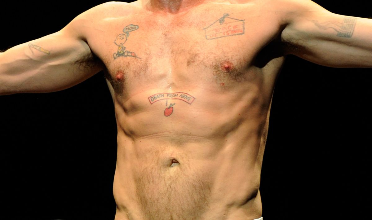 NEW YORK, NY - APRIL 10:  (Exclusive Coverage) Charlie Sheen's tattoos while he speaks on stage during his "Violent Torpedo of Truth/Defeat Is Not An Option" tour at Radio City Music Hall on April 10, 2011 in New York City.  (Photo by Kevin Mazur/WireImage)