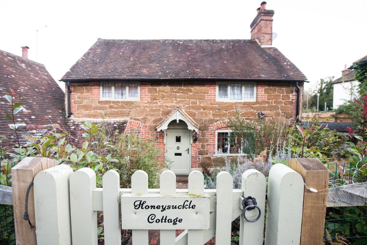 Honeysuckle cottage which inspired the one built in the film The Holiday, Holmbury St Mary, Dorking. See SWNS story SWOCholiday. A couple bought the real life cottage from Christmas romcom 'The Holiday' without realising - and now have tourists turning up taking photos. Jon Bromley, 57, and wife Cressida, 51, live in the house which inspired Cameron Diaz's rural retreat in the 2006 festive flick. They had no idea it was the quintessential cottage from the movie when they bought it - until they saw news of the sale in a property magazine. Now they regularly have movie fans turning up to their home in Holmbury St Mary, Surrey, to take photos and pose outside.