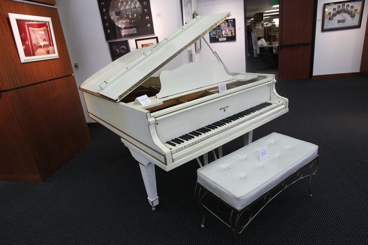 Elvis Presley's Beloved White Knabe Grand Piano and Bench as Featured in His Music Room at Graceland from 1957 to 1969 is displayed during a media preview June 22, 2016 at Heritage Auctions in Beverly Hills, California. The piano is one of the items offered in a live auction June 24-25. (Photo by Tommaso Boddi / AFP)
