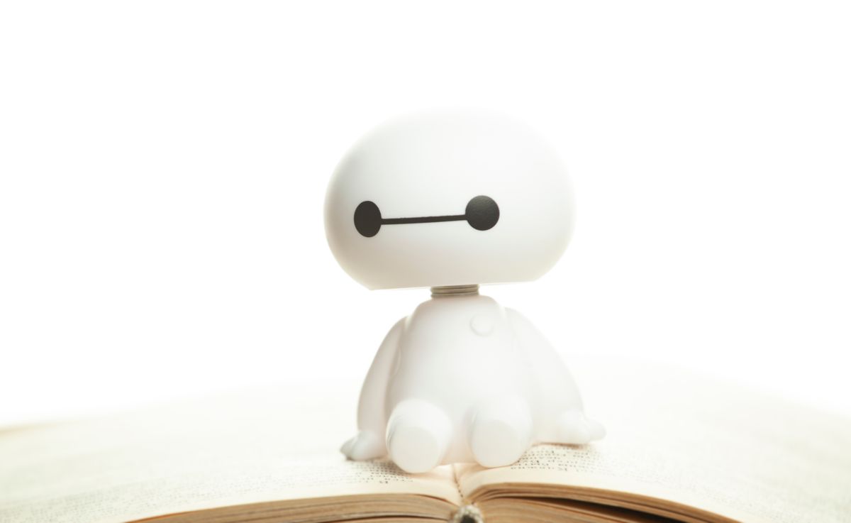 AI robot ül egy könyvön