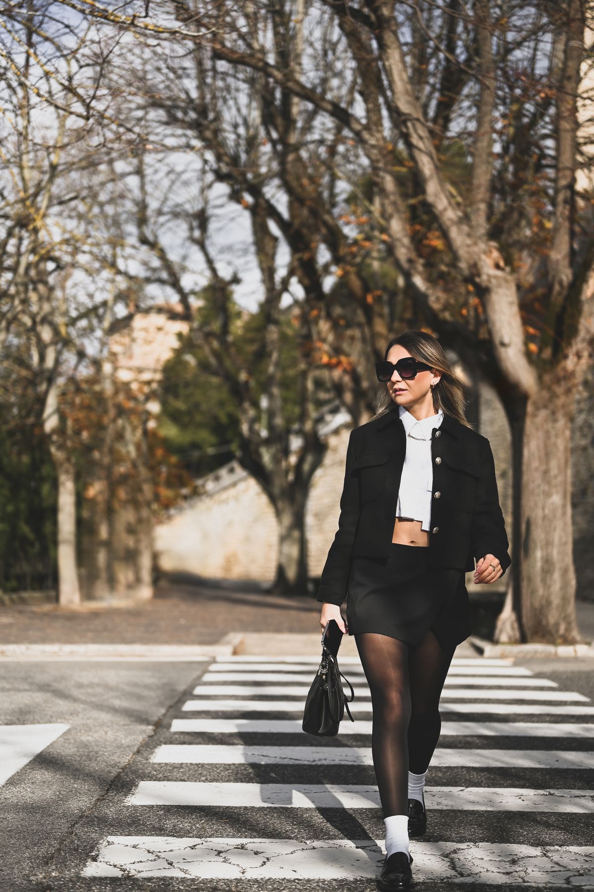 Young woman crossing the road.