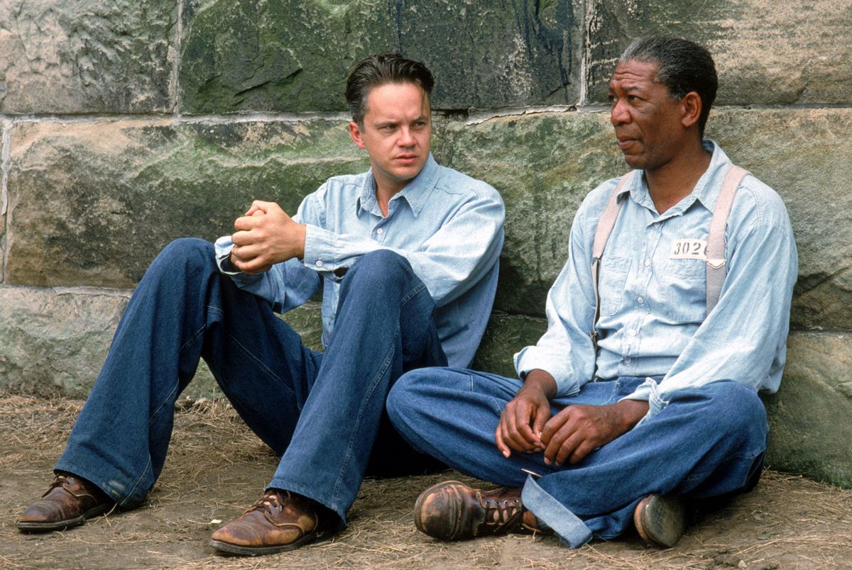 June 15, 1994 - . For merchandising, please contact James Feltham, james.feltham@itv.com....'The Shawshank Redemption' Film .Andy Dufresne (Tim Robbins), Right, and Ellis Boyd ''Red'' Redding (Morgan Freeman) , Who Wears a Baseball Glove, Chat Whilst Kneeling Down, in the Prison Courtyard.