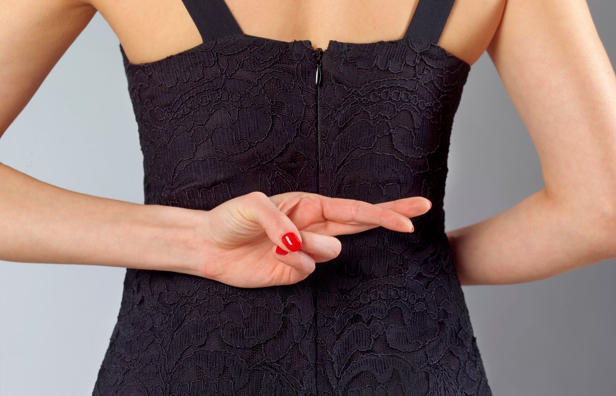 Egy nő az ujjait keresztbe teszi, így jelzi a megcsalást. 