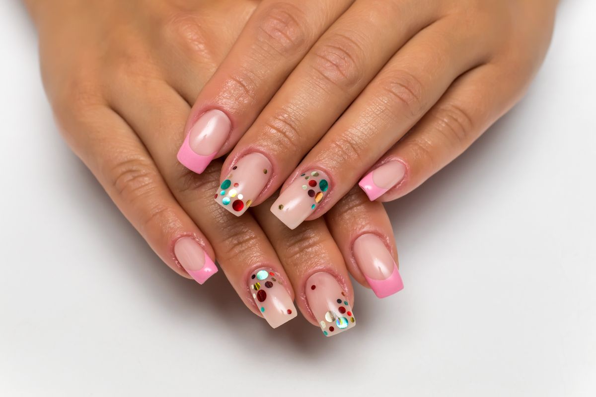 wedding french gently pink manicure with sparkles of confetti on long square nails