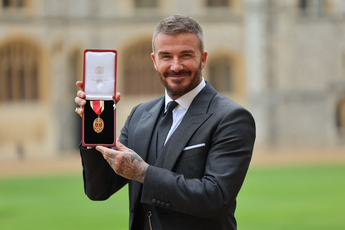 WINDSOR, ENGLAND - NOVEMBER 4: Sir David Beckham poses with his medal after receiving his knighthood for services to sport and charity at Windsor Castle on November 4, 2025 in Windsor, England. (Photo by Richard Pohle - Pool/Getty Images)