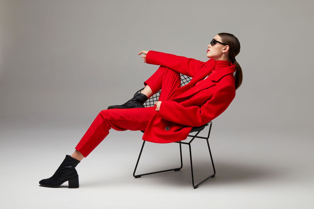Fashion woman in trendy red outfit. Total red look, sunglasses, red coat, poloneck, pants