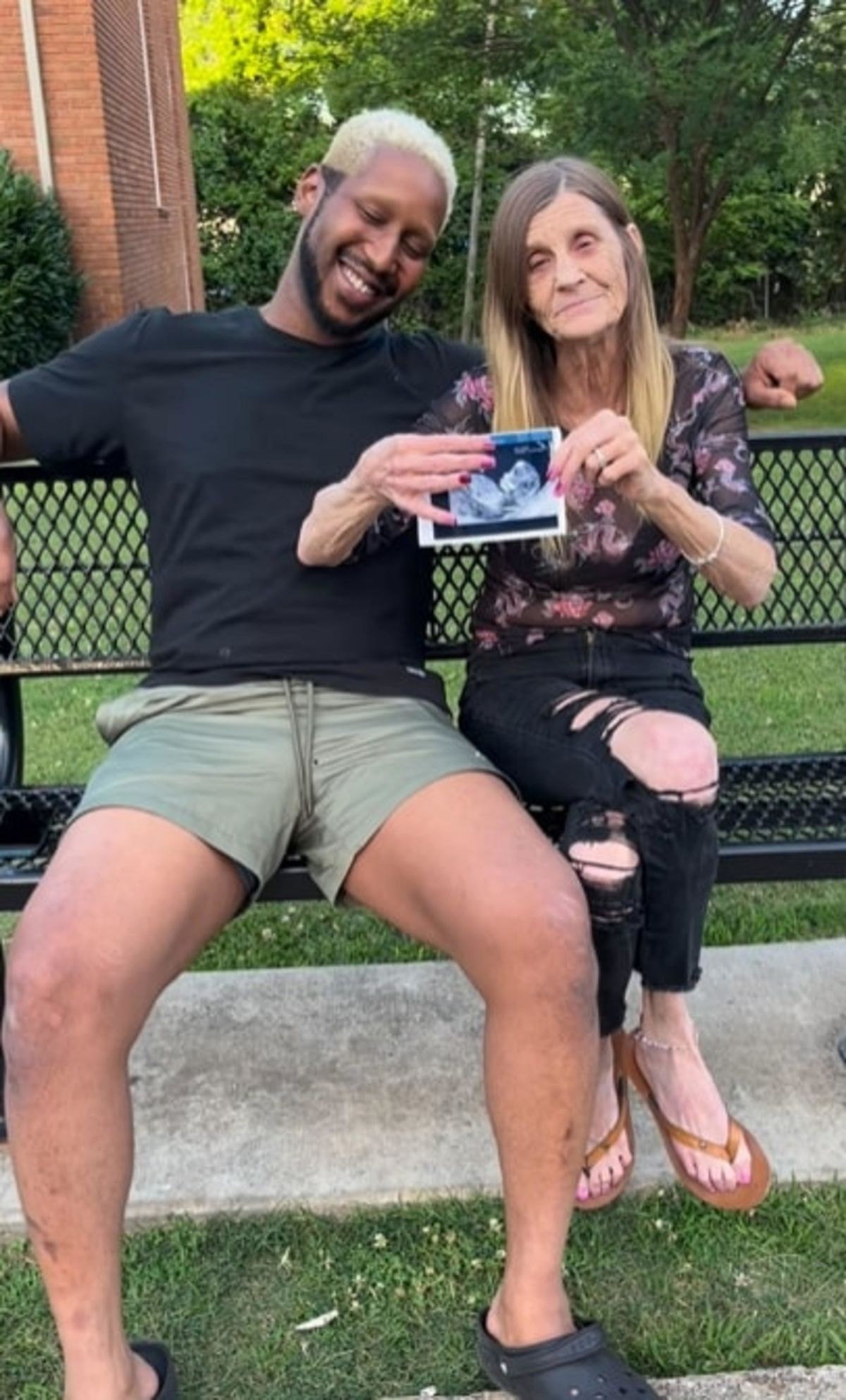 Quran smiling with fist pump and Cheryl sat on bench with baby scan. ROME, GEORGIA: FOOTAGE shows how this grandmother married to a man 37 YEARS younger than her hosted a gender reveal party as she prepares to become a mom for the EIGHTH time. Cheryl McGregor (63), from Rome, Georgia, in the US is a mother-of-seven and a grandmother-of-17 who met her husband Quran McCain (26) in 2012 when he was just 15 years old and she was 52. The couple revealed the upcoming birth of their first child with a gender reveal party, complete with confetti and smoke cannons. The couple actively share their love online, and the couple revealed last year that they would be having a child via surrogacy, since Cheryl is unable to naturally conceive due to her age. Now, they have once again shared an update about their baby, while revealing footage of themselves at their gender reveal. In the video, which has over 12 million views, Cheryl is wearing a pink dress with a sash that says, 'Mommy to be.' The couple first try to pop a balloon to discover whether they will be having a girl or boy, but when both blue and pink confetti came out of the balloon, they realised they were tricked by their loved ones and the real gender reveal was taking place outside. The soon-to-be parents went outside and they each grabbed a smoke cannon. After setting them off, they discovered they would be having a baby girl. As soon as Cheryl saw the pink clouds of smoke in the air, the grandmother-of-17 began cheering and jumping up and down as she held onto her 26-year-old husband. The pair first met in 2012, when Quran was just 15 years old while they were working at the fast food chain Dairy Queen. But romantic feelings didn't blossom until much later, as they lost contact but reconnected in 2020 when caretaker Quran saw Cheryl working as a cashier at a convenience store. The couple began dating and they then got married in 2021 after Quran proposed on a live stream with 20K people watching. Soon after the couple started dating, they began posting videos of themselves on TikTok and they have now become viral sensations on the platform because of their nearly four-decade age difference. The pair also set up an Only Fans account for their saucier content. This viral gender reveal video was captioned with: 'It's a girl.' Fans flooded the comments section and congratulated the couple on their parenthood. One person said: 'Why can’t some people be happy for others, why all the hateful comments congrats queen.' Another user added: “That’s so cute. And y’all need to stop judging people without knowing their story first.” 'Awwww she’s look soooo happy,' a different user commented. Someone else wrote: 'Congratulations king and queen.' However, others criticised the pair due to their age difference. One user wrote sarcastically: 'Aw, she’s going to be the best grandma.' Someone else commented: 'The way I ran to these comments! Am I being pranked???.' Another person added: ‘Hope she gets to see the baby. When it is born.' Addressing their age gap, Cheryl previously shared: 'We understand that I may not be there for as long as Quran is, but I have faith in him. 'If I am not here, he can do it. He's gonna be a great father, he's a responsible adult. I had every bit of faith that he could raise our child, and do it very well. 'Our family is also very supportive of our decision to have children. At first they were hesitant for the same reasons. 'However, now five of my children have come to accept the idea, and my mother-in-law and I make videos together.' The couple have regularly come under fire from trolls online due to their unconventional relationship, but that doesn't phase them. Quran previously said: 'People on social media have a lot of hate for us. They say I'm dating my grandmother. 'I am not. She is younger than my grandmother. We are no different from any other couple - love is love. 'No matter what they say or do, it can't hurt us. We know the stuff that they say isn't true, and they believe it. We feel sorry for them. 'We get a lot of hate, but it doesn't phase us. At the end of the day, we still got each other, and that's all that matters.’ mediadrumimages / @oliver6060
