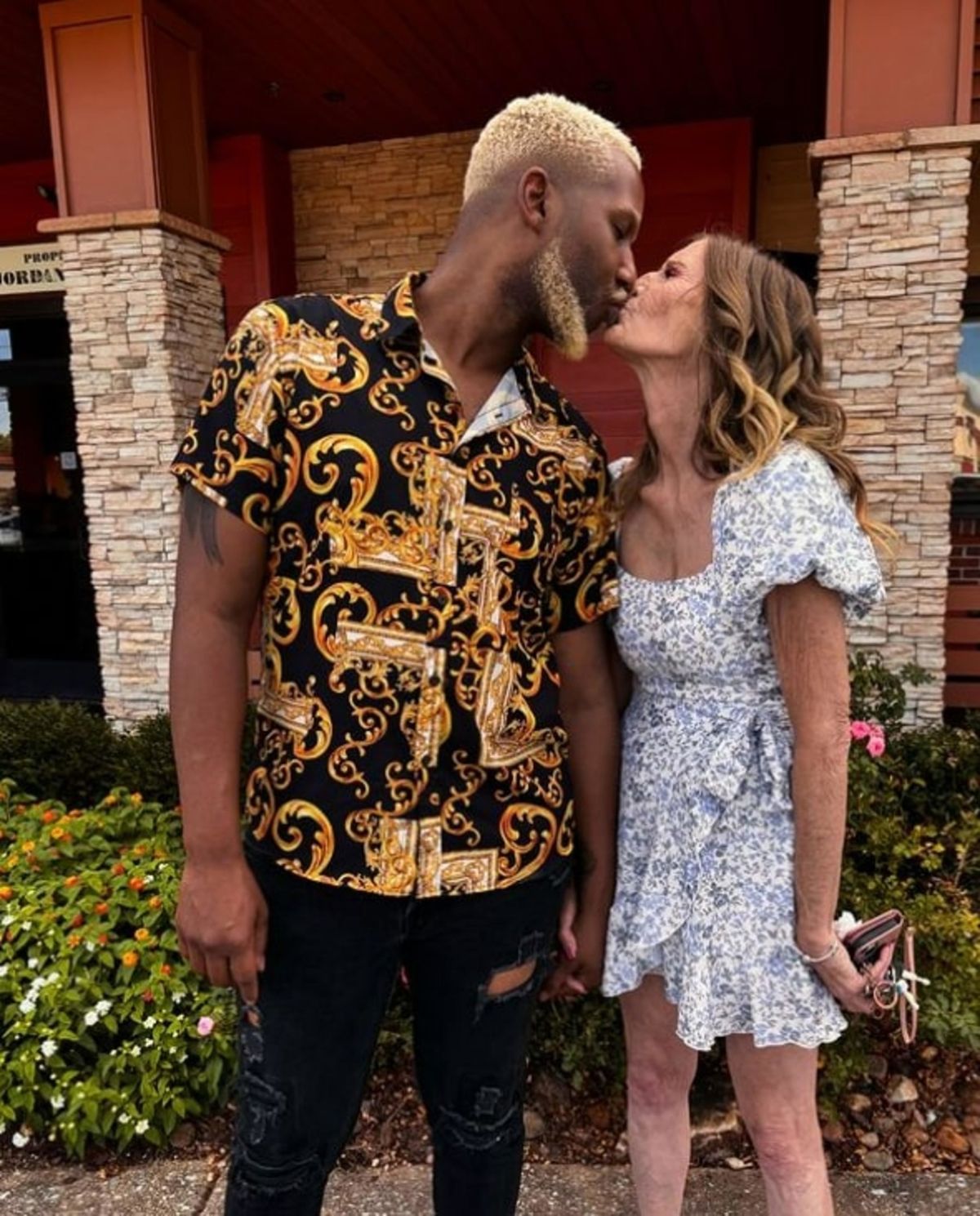 Quran wearing black and gold top kissing Cheryl. ROME, GEORGIA: FOOTAGE shows how this grandmother married to a man 37 YEARS younger than her hosted a gender reveal party as she prepares to become a mom for the EIGHTH time. Cheryl McGregor (63), from Rome, Georgia, in the US is a mother-of-seven and a grandmother-of-17 who met her husband Quran McCain (26) in 2012 when he was just 15 years old and she was 52. The couple revealed the upcoming birth of their first child with a gender reveal party, complete with confetti and smoke cannons. The couple actively share their love online, and the couple revealed last year that they would be having a child via surrogacy, since Cheryl is unable to naturally conceive due to her age. Now, they have once again shared an update about their baby, while revealing footage of themselves at their gender reveal. In the video, which has over 12 million views, Cheryl is wearing a pink dress with a sash that says, 'Mommy to be.' The couple first try to pop a balloon to discover whether they will be having a girl or boy, but when both blue and pink confetti came out of the balloon, they realised they were tricked by their loved ones and the real gender reveal was taking place outside. The soon-to-be parents went outside and they each grabbed a smoke cannon. After setting them off, they discovered they would be having a baby girl. As soon as Cheryl saw the pink clouds of smoke in the air, the grandmother-of-17 began cheering and jumping up and down as she held onto her 26-year-old husband. The pair first met in 2012, when Quran was just 15 years old while they were working at the fast food chain Dairy Queen. But romantic feelings didn't blossom until much later, as they lost contact but reconnected in 2020 when caretaker Quran saw Cheryl working as a cashier at a convenience store. The couple began dating and they then got married in 2021 after Quran proposed on a live stream with 20K people watching. Soon after the couple started dating, they began posting videos of themselves on TikTok and they have now become viral sensations on the platform because of their nearly four-decade age difference. The pair also set up an Only Fans account for their saucier content. This viral gender reveal video was captioned with: 'It's a girl.' Fans flooded the comments section and congratulated the couple on their parenthood. One person said: 'Why can’t some people be happy for others, why all the hateful comments congrats queen.' Another user added: “That’s so cute. And y’all need to stop judging people without knowing their story first.” 'Awwww she’s look soooo happy,' a different user commented. Someone else wrote: 'Congratulations king and queen.' However, others criticised the pair due to their age difference. One user wrote sarcastically: 'Aw, she’s going to be the best grandma.' Someone else commented: 'The way I ran to these comments! Am I being pranked???.' Another person added: ‘Hope she gets to see the baby. When it is born.' Addressing their age gap, Cheryl previously shared: 'We understand that I may not be there for as long as Quran is, but I have faith in him. 'If I am not here, he can do it. He's gonna be a great father, he's a responsible adult. I had every bit of faith that he could raise our child, and do it very well. 'Our family is also very supportive of our decision to have children. At first they were hesitant for the same reasons. 'However, now five of my children have come to accept the idea, and my mother-in-law and I make videos together.' The couple have regularly come under fire from trolls online due to their unconventional relationship, but that doesn't phase them. Quran previously said: 'People on social media have a lot of hate for us. They say I'm dating my grandmother. 'I am not. She is younger than my grandmother. We are no different from any other couple - love is love. 'No matter what they say or do, it can't hurt us. We know the stuff that they say isn't true, and they believe it. We feel sorry for them. 'We get a lot of hate, but it doesn't phase us. At the end of the day, we still got each other, and that's all that matters.’ mediadrumimages / @oliver6060