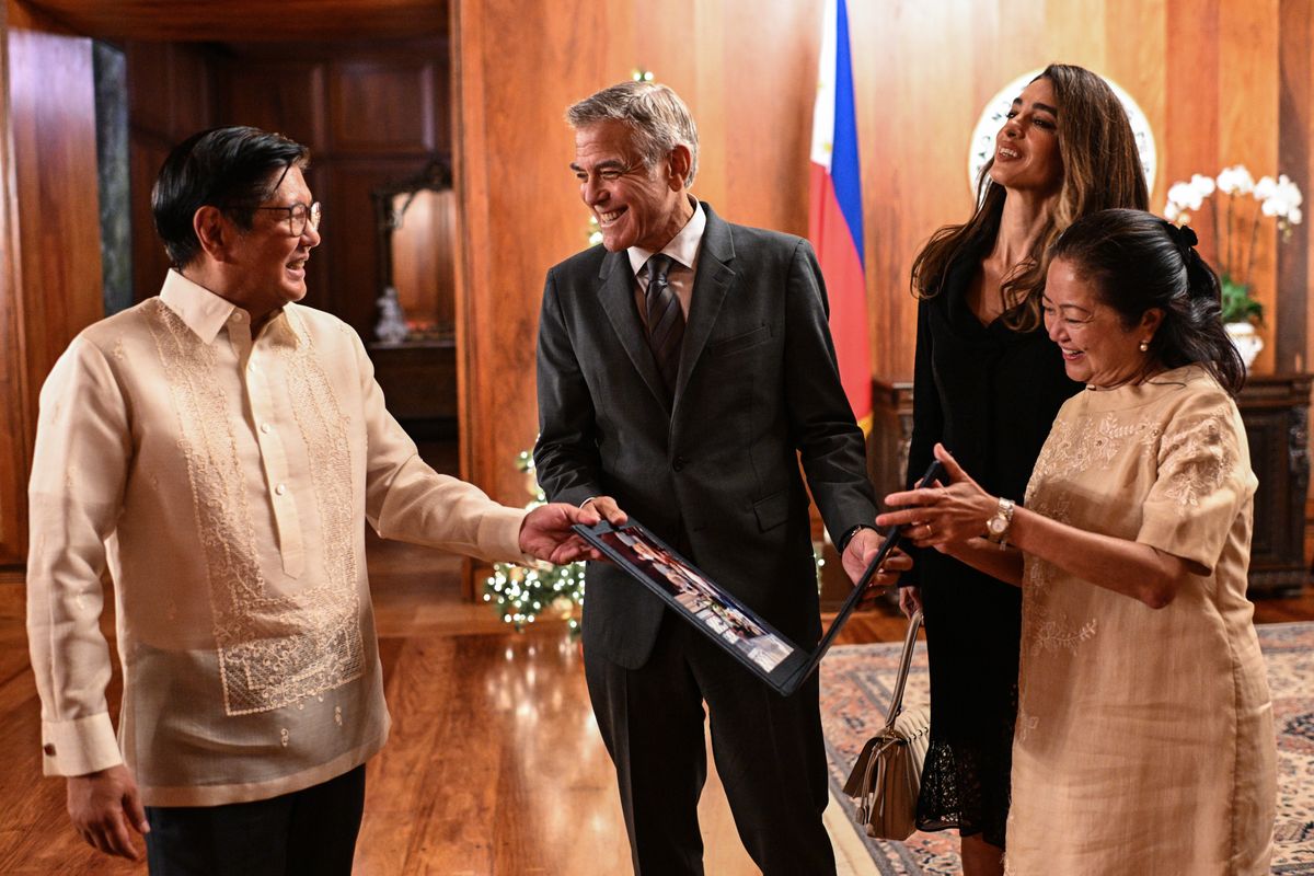 MANILA, PHILIPPINES - NOVEMBER 14: Actor George Clooney (2L) and Amal Clooney (2R) receive a photo souvenir from Philippine President Ferdinand Marcos Jr. (L) and First Lady Liza Araneta Marcos at Malacañang Palace on November 14, 2025 in Manila, Philippines. George and Amal Clooney are in the Philippines to speak at the Social Good Summit, an event hosted by news website Rappler. (Photo by Noel Celis - Pool/Getty Images)