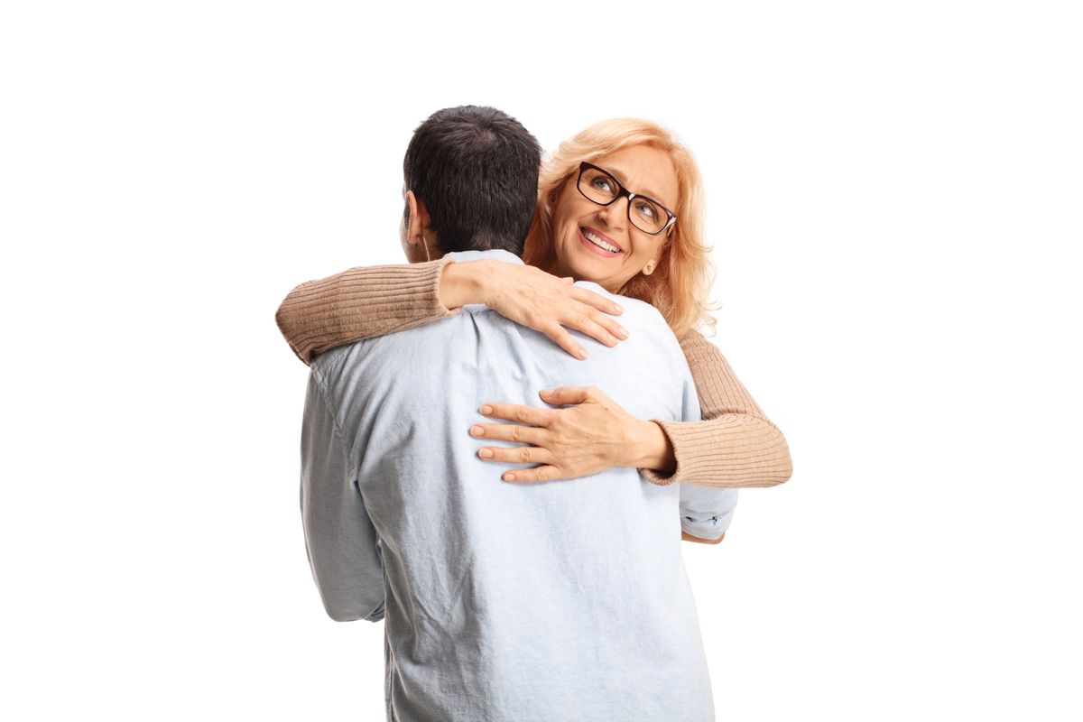 Happy woman smiling and hugging a man isolated on white background