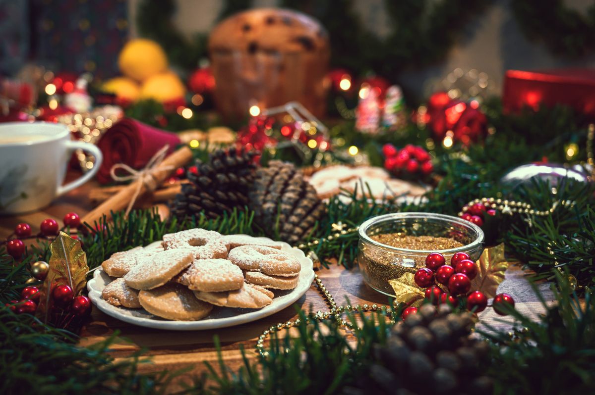 Christmas ingredients table with a cookies in the center on a wo