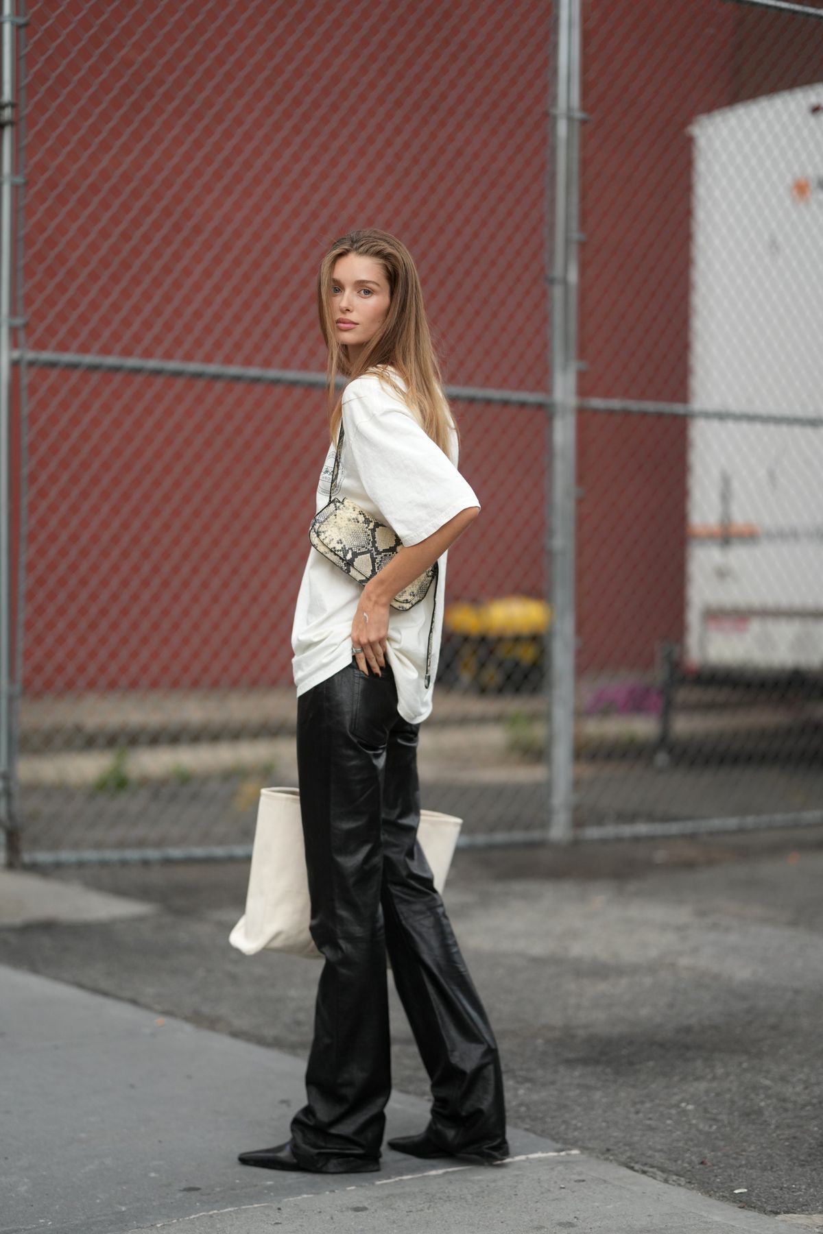 NEW YORK, NEW YORK - SEPTEMBER 15: Stella Hanan is seen wearing a white short sleeve t-shirt, black leather pants and carrying an animal print shoulder bag with black pointy toed shoes outside of the Tory Burch show, during New York Fashion Week on September 15, 2025 in New York City. (Photo by 305pics/Getty Images)