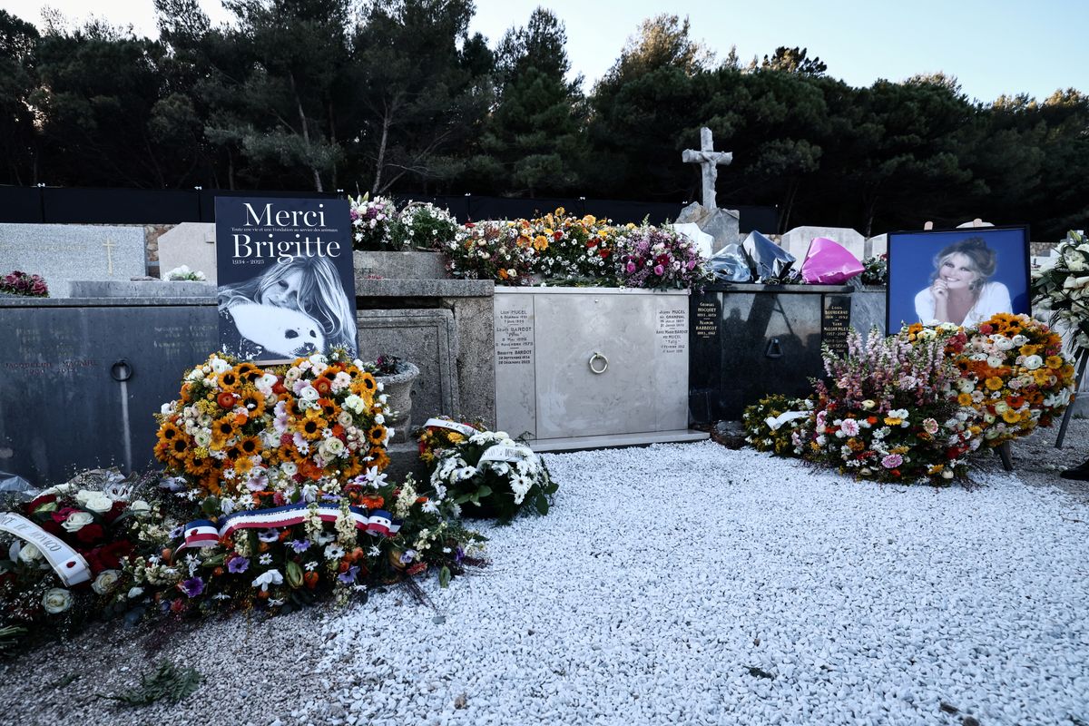 Wreath of flowers and photographs of late French actress Brigitte Bardot are pictured around her grave at the marine cemetery, following the funeral ceremony at Notre-Dame de l'Assomption church, in Saint-Tropez, southeastern France, on January 7, 2026. French film sensation Brigitte Bardot, a symbol of sexual liberation in the 1950s and 1960s who reinvented herself as an animal rights defender and embraced far-right views, died on December 28, 2025 aged 91. (Photo by Thibaud MORITZ / AFP)