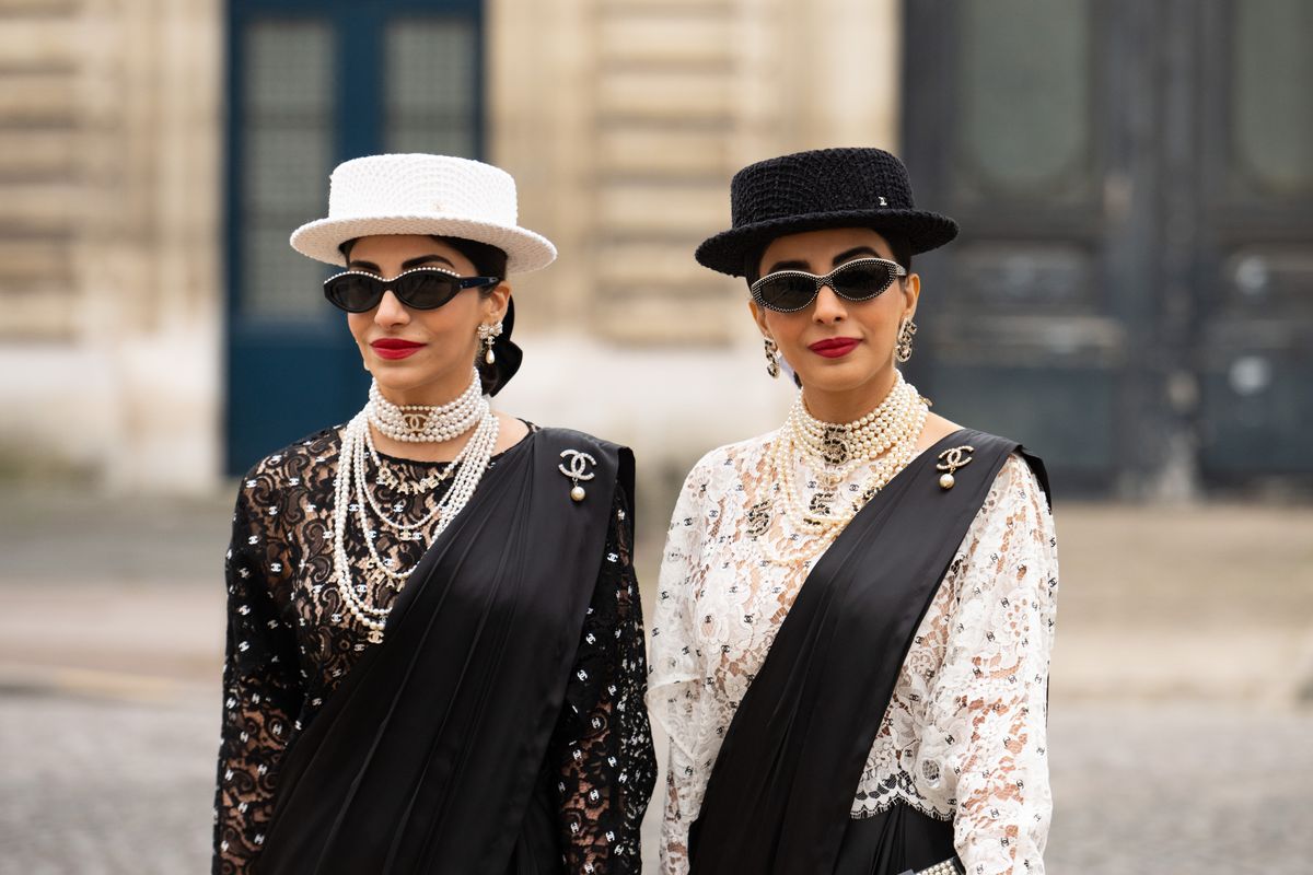 PARIS, FRANCE - JANUARY 23: Snehal Babani and Jyoti Babani wear all Chanel with black silk Saree's outside the Chanel show during the Haute Couture Spring/Summer 2024 as part of  Paris Fashion Week on January 23, 2024 in Paris, France. (Photo by Kirstin Sinclair/Getty Images)