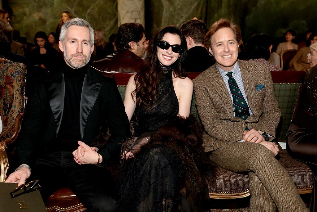 NEW YORK, NEW YORK - FEBRUARY 10: (L-R) Adam Shulman, Anne Hathaway and David Lauren attend the Ralph Lauren fashion show during New York Fashion Week on February 10, 2026 in New York City.  (Photo by Dimitrios Kambouris/Getty Images)