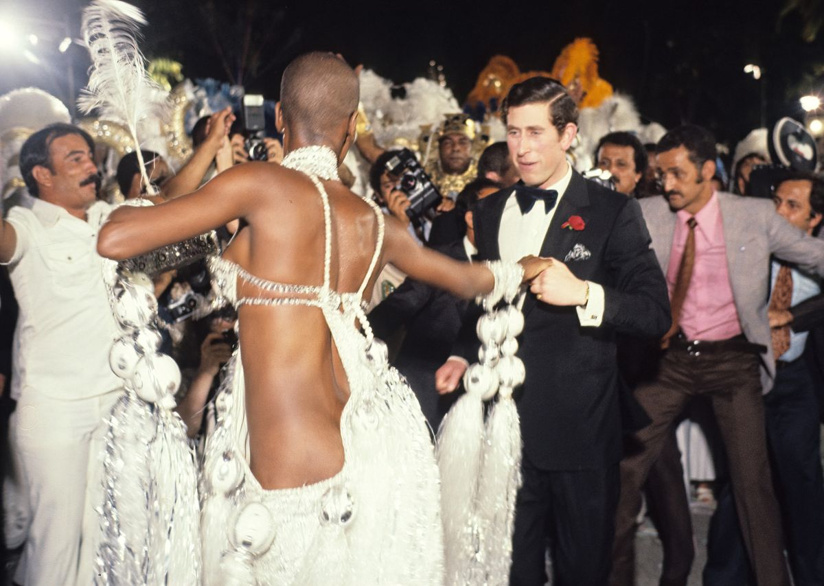 Carnival performer Pinah Ayoub (also known as Pina de Beija-Flor or Beija-Flora) (left) and Prince Charles, Prince of Wales (in tuxedo) samba dance during a street party at the Town Hall, Rio de Janeiro, Brazil, between March 8 & 16, 1978. (Photo by John Scott/Princess Diana Museum/Getty Images)