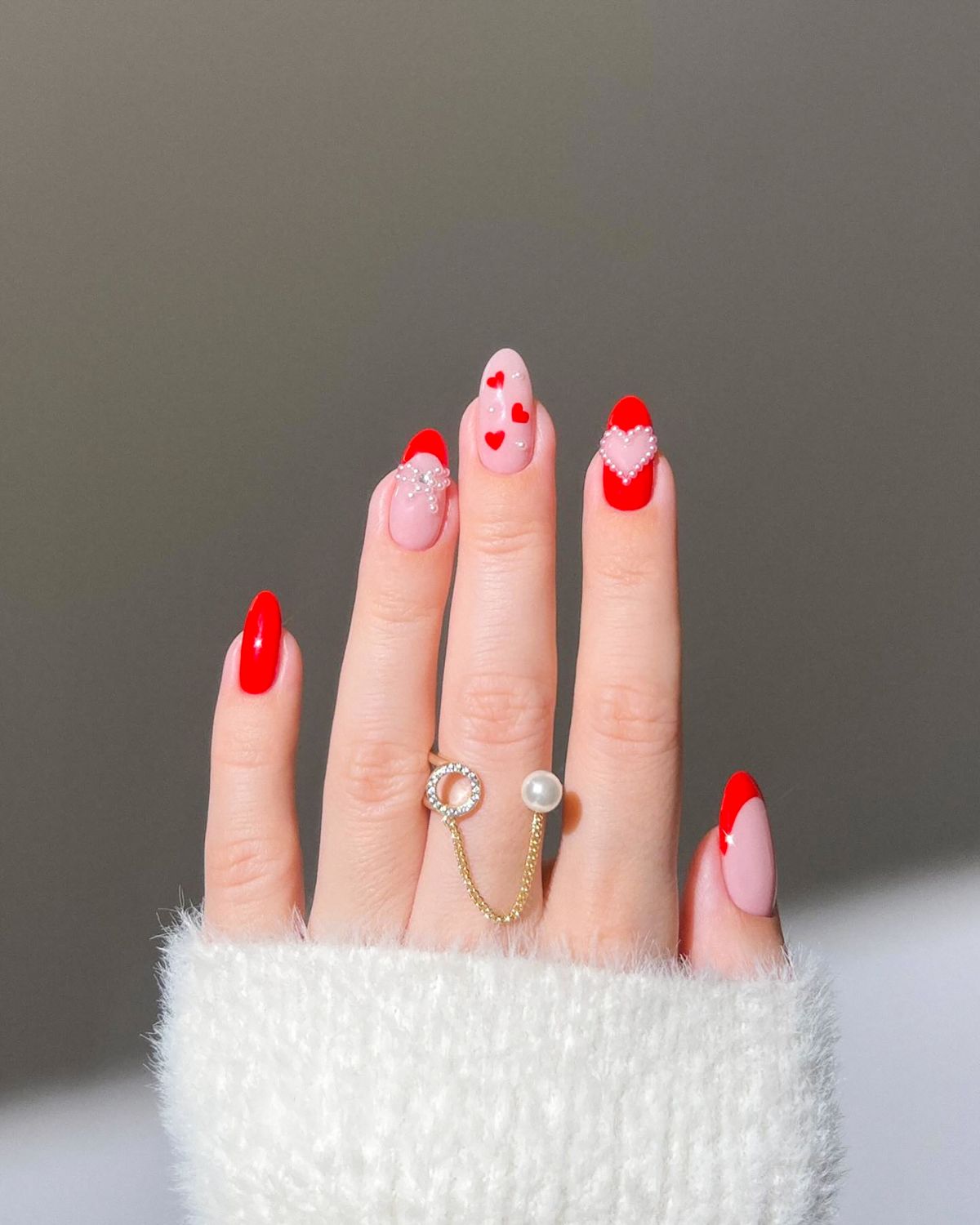 Oval nails with red heart designs for the Valentine’s season. Valentine nail art, Red heart nails, Oval nail design