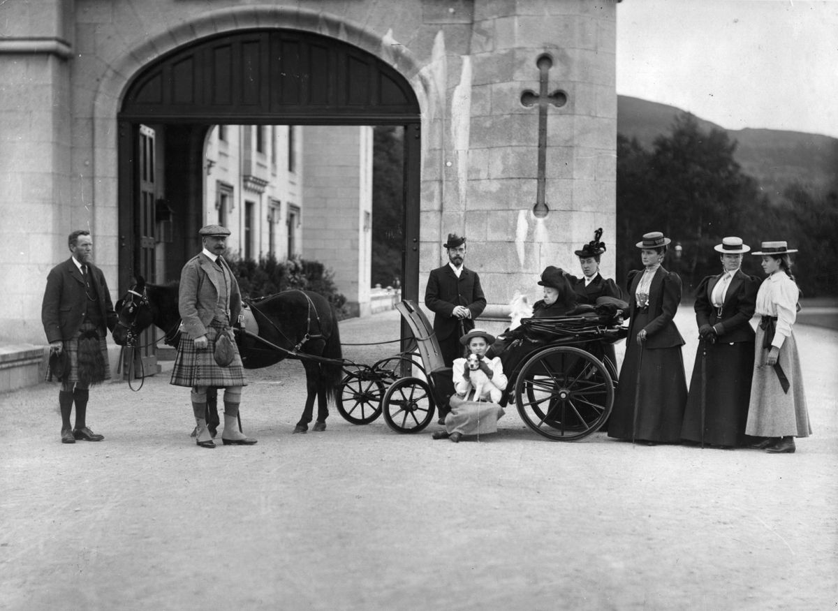 Queen Victoria at Balmoral in a pony and trap with attendant servants and family. Victoria's late husband, Prince Albert, purchased Balmoral Castle in 1846, and the small castle which stood in the 7,000 hectare wooded estate was redeveloped in the 1850?s. The granite building was designed by Aberdeen architect William Smith with suggestions from Albert himself who decided the interior decoration should represent a Highland shooting box with tartan or thistle chintzes, and walls decorated with trophies and weapons. Queen Victoria often visited the Highlands with her family, especially after Albert?s death, and the building is still a popular retreat for the present royal family.  Original Publication: People Disc - HU0190   (Photo by W & D Downey/Hulton Archive/Getty Images)