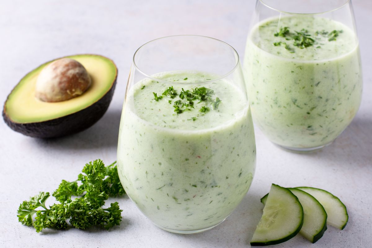 Avocado and Herb Infused Soup with Crunchy Vegetable Topping styled and decorated in rustic bowl