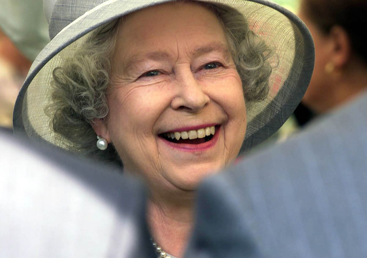 Britain's Queen Elizabeth II meets the public before visiting the Sunbury Millennium Embroidery, in the walled garden, Sunbury on Thames, Middlesex.   *...The embroidery, which took 200 people five years to sew, represented the history and landmarks of the village, including a local yew tree written about by Charles Dickens in Oliver Twist, the house where Edward VIII courted Freda Dudley-Ward before his next love Wallis Simpson, and the current village sub-postmaster Albert Skinner.   (Photo by PA Images via Getty Images)