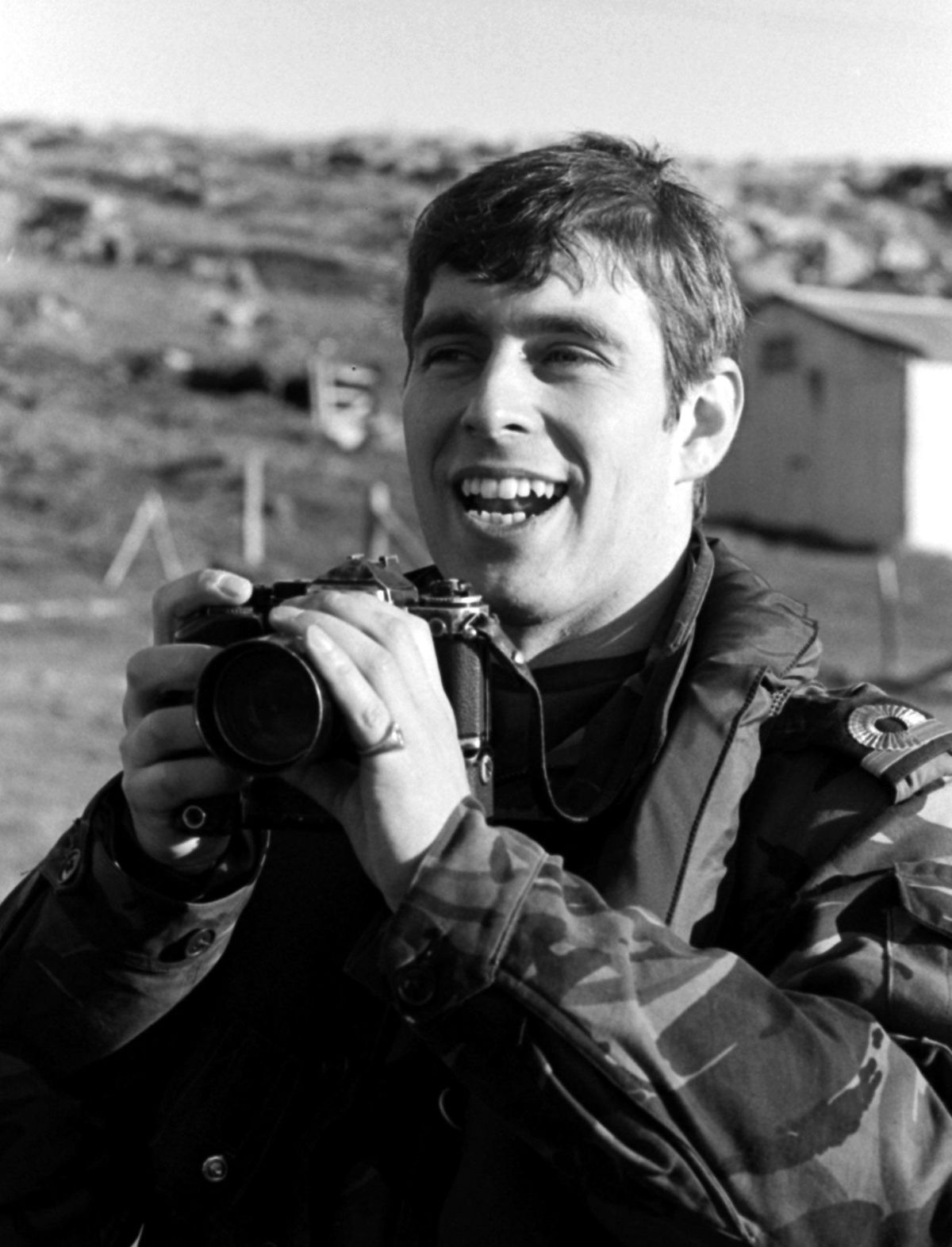 A new Royal photographer, in the shape of Prince Andrew, recording for private posterity, scenes at Port Stanley after the Falklands conflict in which he took part as a helicopter pilot with HMS Invincible.   (Photo by Martin Cleaver - PA Images/PA Images via Getty Images)