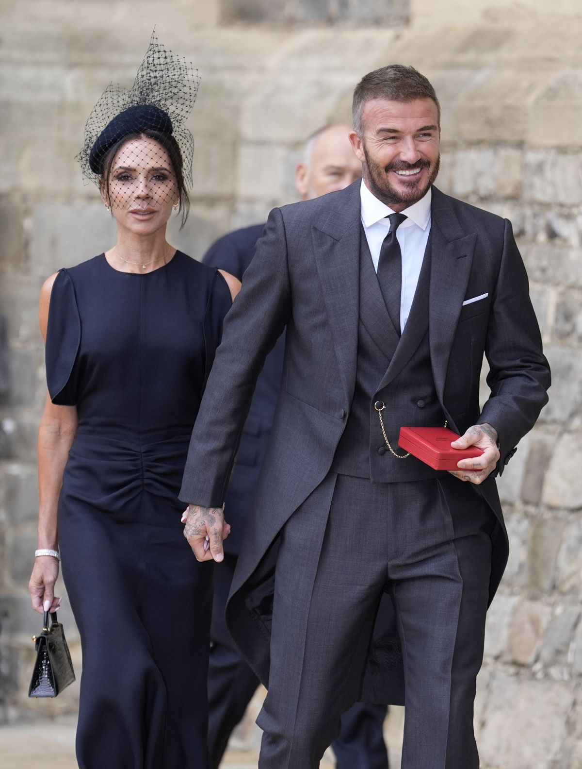 WINDSOR, ENGLAND - NOVEMBER 4: Sir David Beckham walks with his wife Lady Victoria after he was made a Knight Bachelor at an investiture ceremony at Windsor Castle on November 4, 2025 in Windsor, England. (Photo by Andrew Matthews - Pool/Getty Images)