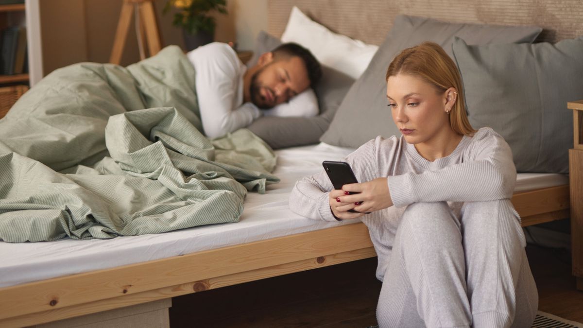 Egy párkapcsolat mellett betitokban beszélget egy nő a telefonján, amíg a férfi alszik mellette. 
