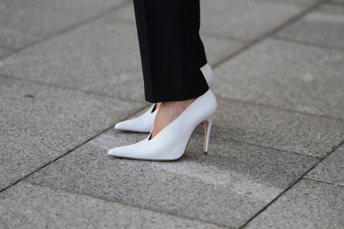 PARIS, FRANCE - MARCH 08: A guest wears guest wears black tailored trousers, white leather pointed pumps heels shoes, outside Magda Butrym, during Paris Fashion Week - Womenswear Fall/Winter 2026/2027, on March 08, 2026 in Paris, France (Photo by Edward Berthelot/Getty Images)