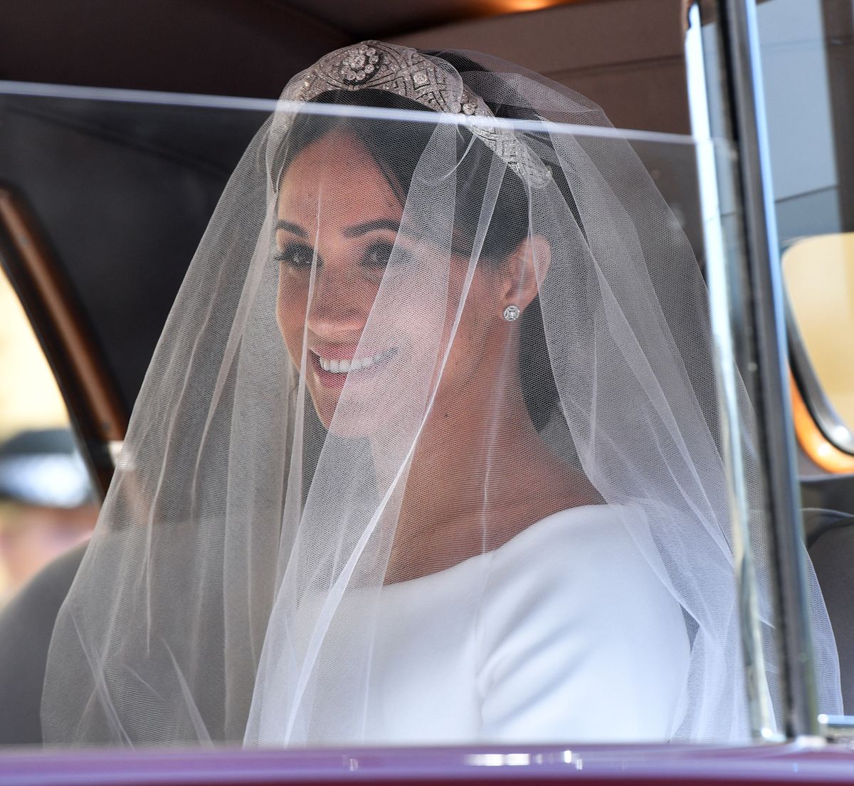 WINDSOR, UNITED KINGDOM - MAY 19: (EMBARGOED FOR PUBLICATION IN UK NEWSPAPERS UNTIL 24 HOURS AFTER CREATE DATE AND TIME) Meghan Markle arrives at St George's Chapel, Windsor Castle for her wedding to Prince Harry on May 19, 2018 in Windsor, England. Prince Henry Charles Albert David of Wales marries Ms. Meghan Markle in a service at St George's Chapel inside the grounds of Windsor Castle. Among the guests were 2200 members of the public, the royal family and Ms. Markle's Mother Doria Ragland. (Photo by Pool/Max Mumby/Getty Images)