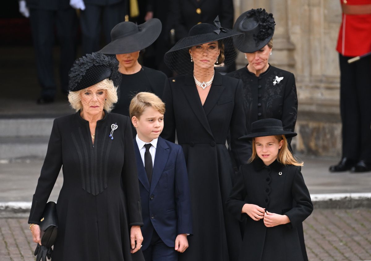 LONDON, ENGLAND - SEPTEMBER 19: (L-R) Camilla, Queen Consort, Meghan, Duchess of Sussex, Prince George of Wales, Catherine, Princess of Wales, Princess Charlotte of Wales and Sophie, Countess of Wessex during the State Funeral of Queen Elizabeth II at Westminster Abbey on September 19, 2022 in London, England. Elizabeth Alexandra Mary Windsor was born in Bruton Street, Mayfair, London on 21 April 1926. She married Prince Philip in 1947 and ascended the throne of the United Kingdom and Commonwealth on 6 February 1952 after the death of her Father, King George VI. Queen Elizabeth II died at Balmoral Castle in Scotland on September 8, 2022, and is succeeded by her eldest son, King Charles III. (Photo by Karwai Tang/WireImage)