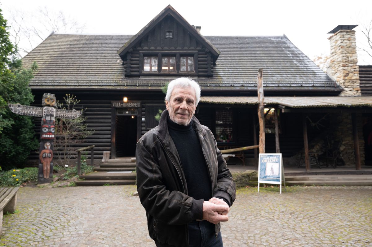 18 April 2023, Saxony, Radebeul: Gojko Mitic, German-Serbian actor and director, stands in front of the "Villa Bärenfett" in the Karl May Museum. Donations made it possible to repair the historic wooden shingle roof on the back of the building. Photo: Sebastian Kahnert/dpa (Photo by Sebastian Kahnert/picture alliance via Getty Images)