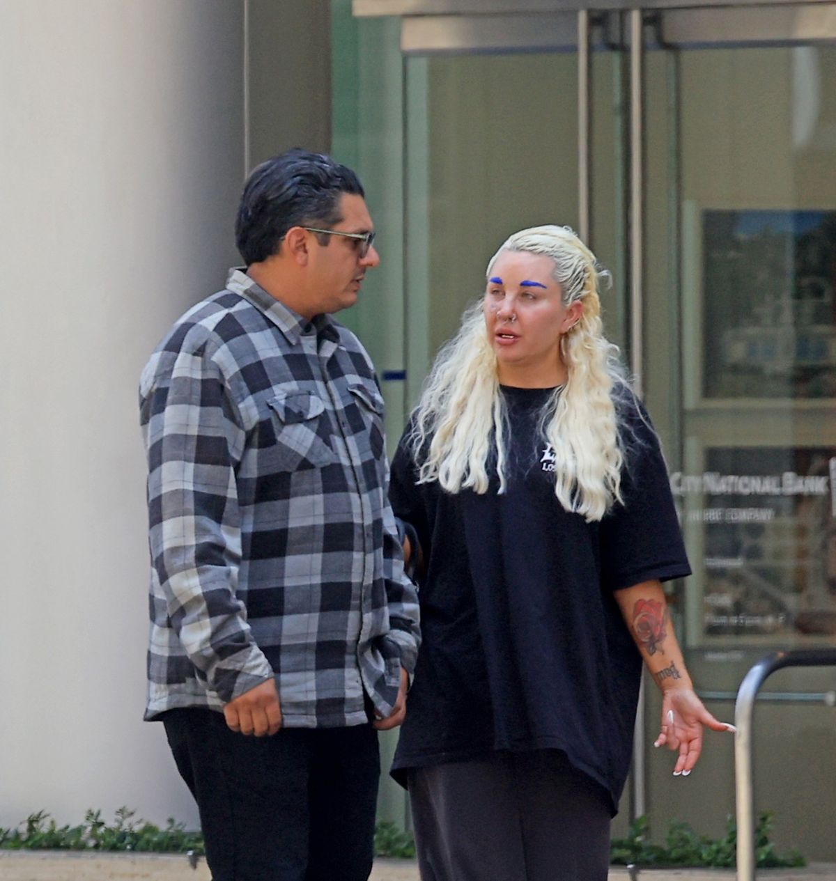*EXCLUSIVE* Los Angeles, CA   Amanda Bynes shows off her new gold bottom grills on her teeth and blue eyebrows as she's seen stepping out with boyfriend Zachary Khan at a local bank in Los Angeles. The 40-year-old former actress is wearing grey trousers, white slippers and a black Dolls Kill t-shirt.       *UK Clients - Pictures Containing Children  Please Pixelate Face Prior To Publication*,Image: 1112537855, License: Rights-managed, Restrictions: , Model Release: no , Pictured: Amanda Bynes, Zachary Khan 