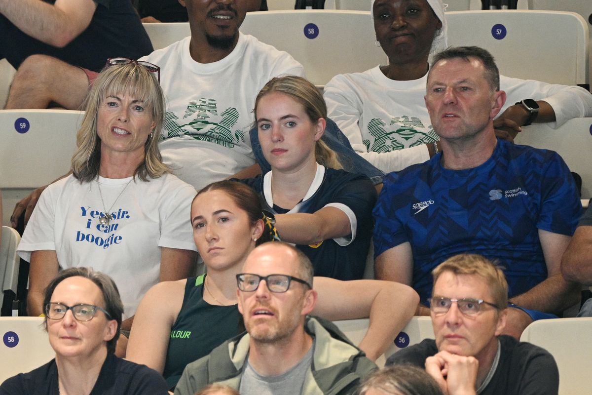Kate (up L) and Gerry McCann (up R), parents of Scotland's Sean McCann, watch as he competes in the Men's 400m Freestyle Final during the swimming event at the Tollcross International Swimming Centre in Glasgow, on day two of the Commonwealth Games in Glasgow, Scotland, on July 25, 2026. (Photo by Oli SCARFF / AFP)