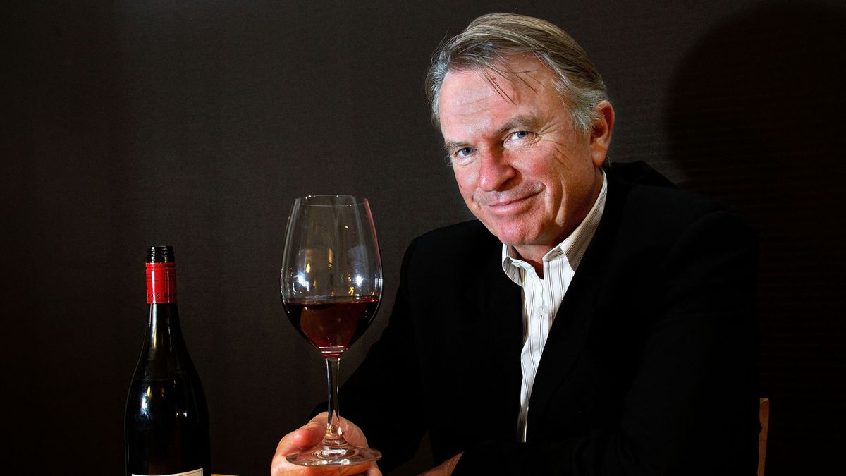(FILES) Actor Sam Neil holds a glass of his Two Paddocks Pinot wine grown on his estate in New Zealand's Central Otago, in Wellington on January 29, 2013. "Jurassic Park" star Sam Neill died in Australia on July 13, 2026 aged 78, according to a family statement that described his death as "sudden and unexpected". (Photo by Marty MELVILLE / AFP)