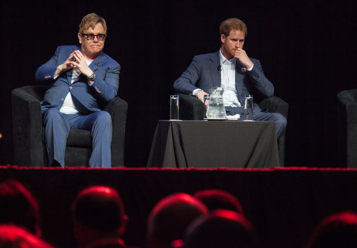 (LtoR) British singer Elton John and Britain's Prince Harry attend the International Aids Conference at the international convention centre in Durban on July 21, 2016. Britain's Prince Harry and Elton John shared a stage in South Africa, warning that complacency threatened efforts to defeat AIDS and urging young people to lead the fight. (Photo by MATTHEW KAY / AFP)