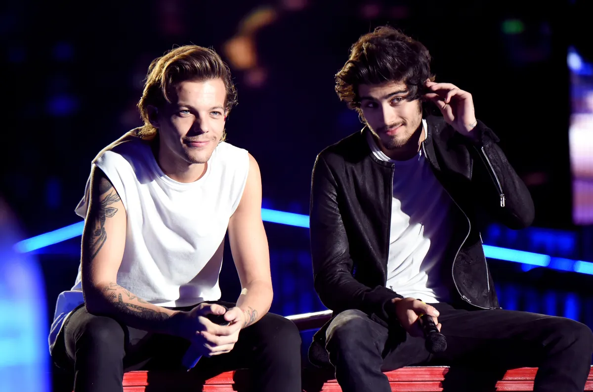 PASADENA, CA - SEPTEMBER 11:  (EDITORIAL USE ONLY; NO COVERS; NO USE IN ANY MAGAZINE OR OTHER PUBLICATION BASED PREDOMINANTLY ON ONE DIRECTION OR ANY ONE OR MORE MEMBERS OF ONE DIRECTION)  Singers Louis Tomlinson (L) and Zayn Malik of One Direction perform onstage during the One Direction" Where We Are" Tour at Rose Bowl on September 11, 2014 in Pasadena, California.  (Photo by Jeff Kravitz/OneD/Getty Images)