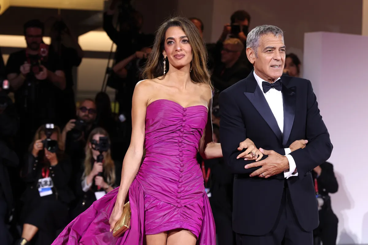 VENICE, ITALY - AUGUST 28: Amal Clooney and George Clooney during the "Jay Kelly" red carpet during the 82nd Venice International Film Festival on August 28, 2025 in Venice, Italy. (Photo by Gisela Schober/Getty Images)