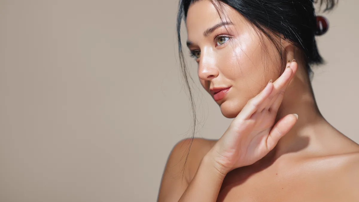 A side profile of a beautiful young woman with glowing skin, soft lighting, and a serene expression. Perfect for skincare advertisements, beauty campaigns, or wellness promotions.