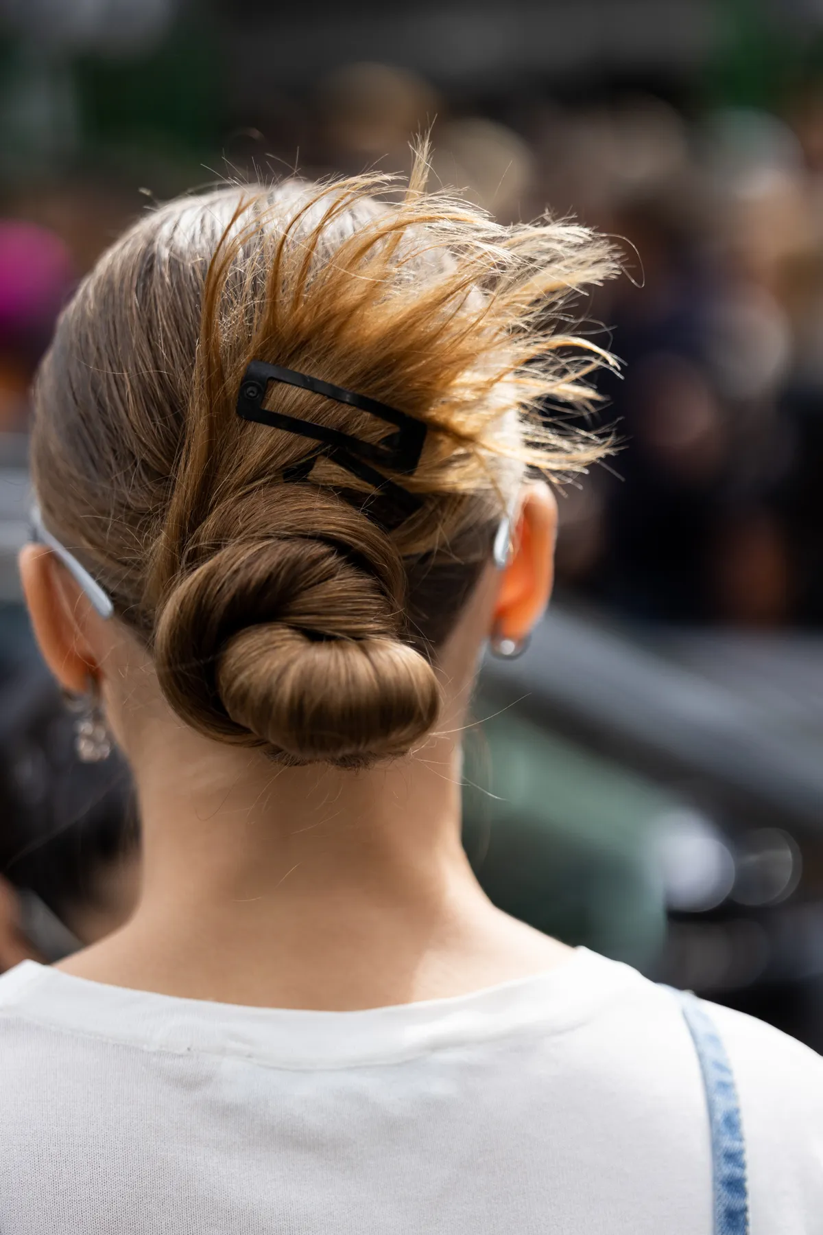 MILAN, ITALY - SEPTEMBER 21: A guest is seen wearing a bun with hairpin at Diesel show during the Milan Fashion Week - Womenswear Spring/Summer 2023 on September 21, 2022 in Milan, Italy. (Photo by Valentina Frugiuele/Getty Images)