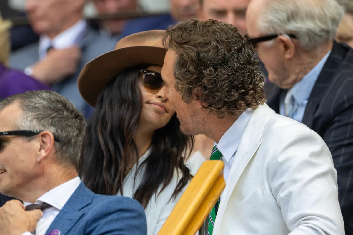LONDON, ENGLAND - JULY 13: Matthew McConaughey and his wife Camila Alves share a kiss in the Royal Box for the Gentlemen's Singles Final on Centre Court during the Wimbledon Lawn Tennis Championships at the All England Lawn Tennis and Croquet Club at Wimbledon on July 13th, 2025, in London, England. (Photo by Tim Clayton/Getty Images)