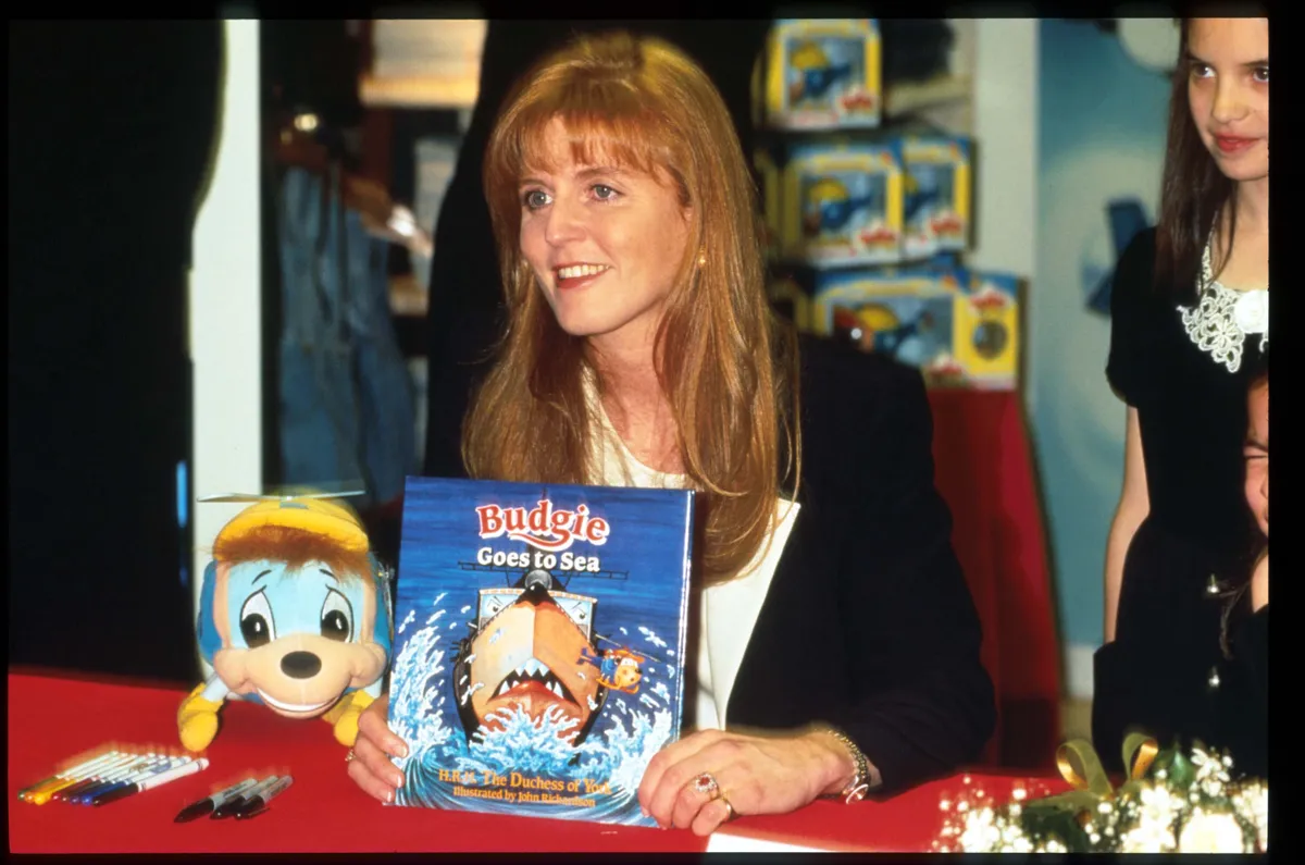 246730 02: Duchess of York Sarah Ferguson holds a copy of her book "Budgie the Little Helicopter" at Bloomingdale's December 2, 1995 in New York City. Ferguson wrote a series of books about the smallest helicopter at the hanger and based them on her own experiences as a Royal Navy pilot. (Photo by Evan Agostini/Liaison)