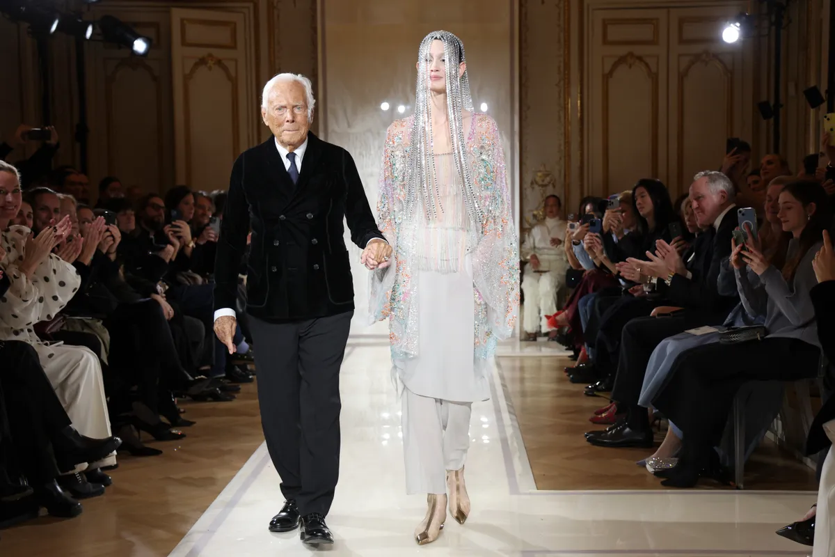 PARIS, FRANCE - JANUARY 28: (EDITORIAL USE ONLY - For Non-Editorial use please seek approval from Fashion House) Giorgio Armani (L) acknowledges the applause of the audience during the Giorgio Armani Privé Haute Couture Spring-Summer 2025 show as part of Paris Fashion Week on January 28, 2025 in Paris, France. (Photo by Pascal Le Segretain/Getty Images)