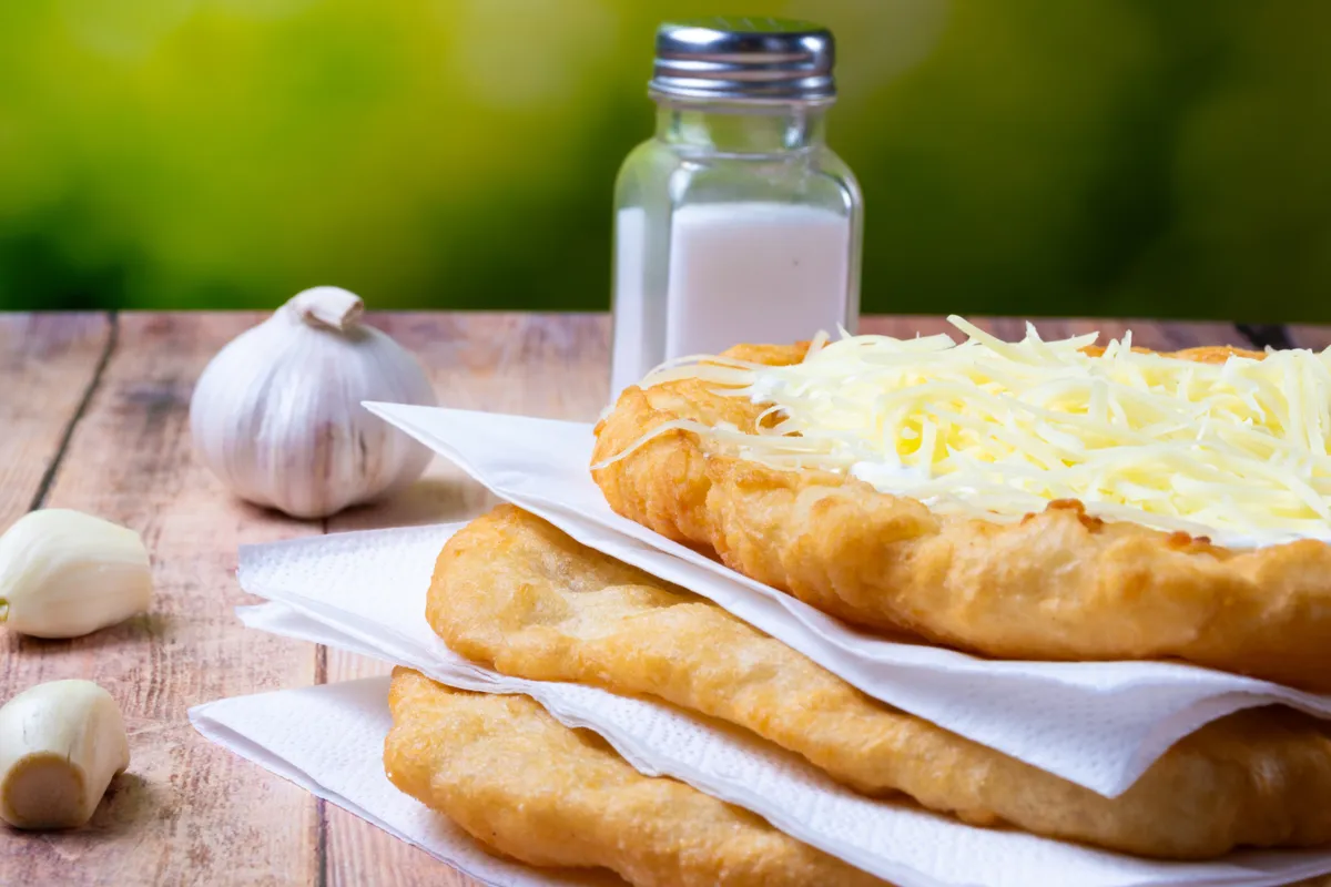 Hungarian deep fried flatbread with cream and cheese