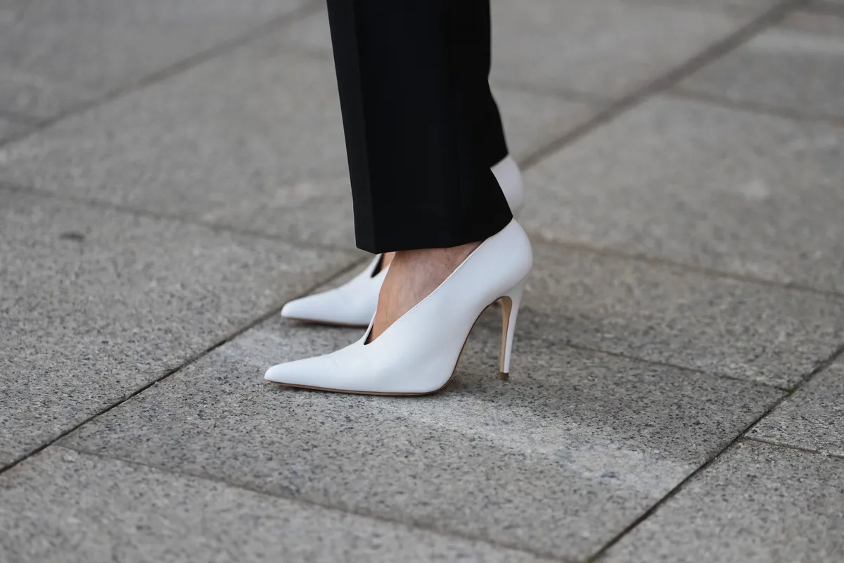 PARIS, FRANCE - MARCH 08: A guest wears guest wears black tailored trousers, white leather pointed pumps heels shoes, outside Magda Butrym, during Paris Fashion Week - Womenswear Fall/Winter 2026/2027, on March 08, 2026 in Paris, France (Photo by Edward Berthelot/Getty Images)