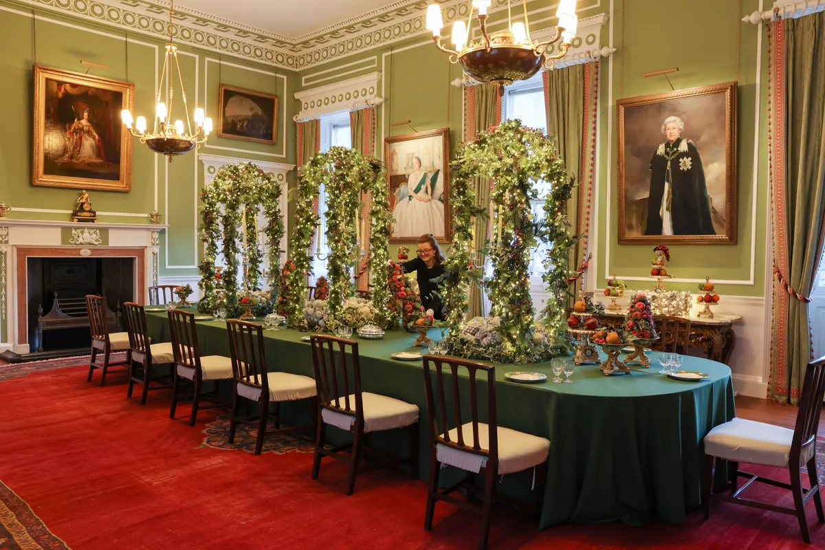 EDINBURGH, SCOTLAND - NOVEMBER 20: The curator make final adjustments in the dining room the Palace of Holyroodhouse on November 20, 2025 in Edinburgh, Scotland. The Palace of Holyroodhouse, also known as Holyrood Palace, is the official residence of the British monarch in Scotland. During the festive season, the palace is dressed with Christmas decorations, including two 12-foot-high (3.7-metre) Christmas trees. (Photo by Robert Perry/Getty Images)