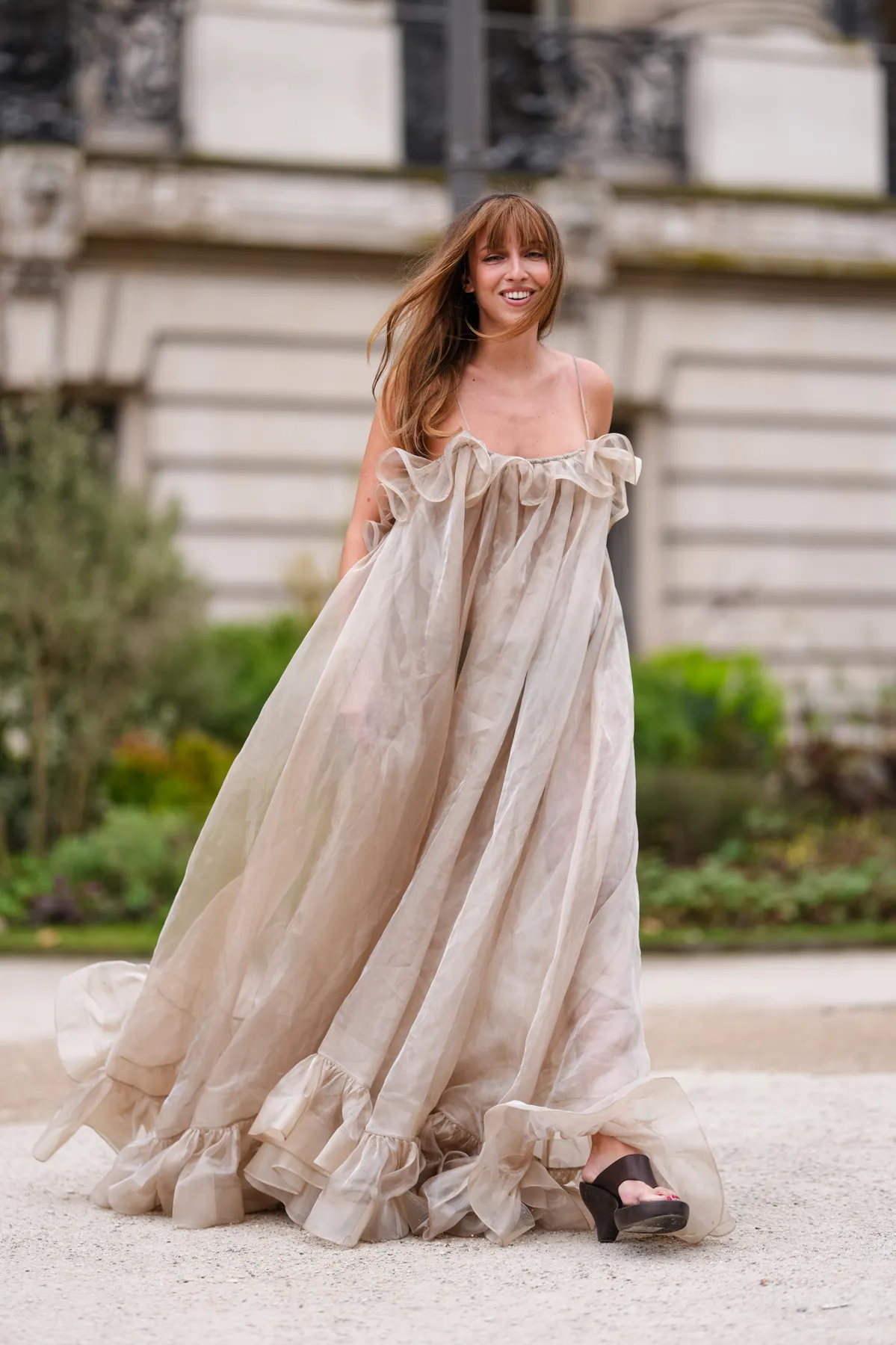 PARIS, FRANCE - MARCH 10: Carla Ginola wears light brown sheer mesh Zimmermann maxi dress, outside Zimmermann, during the Paris Fashion week Women's Fall/Winter 2025-2026 on March 10, 2025 in Paris, France. (Photo by Edward Berthelot/Getty Images)