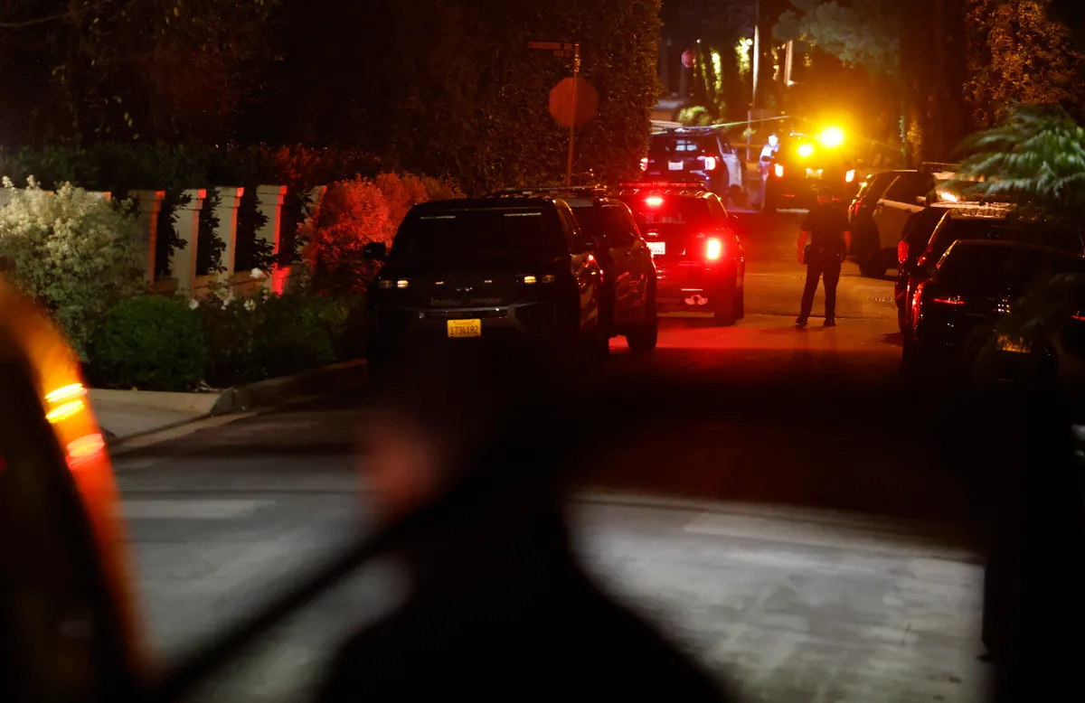BRENTWOOD, CALIFORNIA - DECEMBER 14: LAPD officers keep watch as the police investigate two people found dead in Rob Reiner's home on December 14, 2025 in Brentwood, California. The LAPD confirmed that the deceased are Rob Reiner and his wife Michele Singer Reiner. (Photo by Mario Tama/Getty Images)