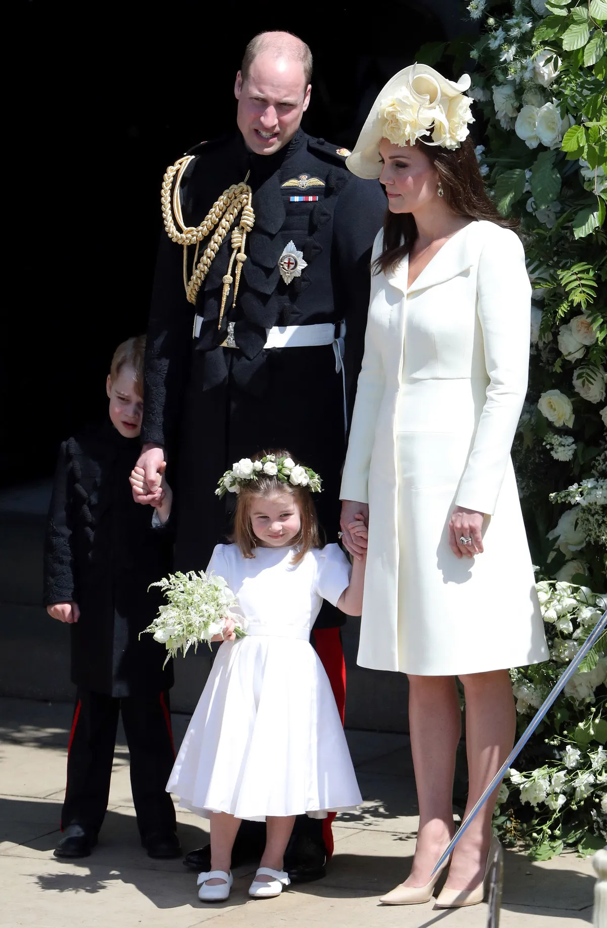WINDSOR, UNITED KINGDOM - MAY 19: Prince William, Duke of Cambridge and Catherine, Duchess of Cambridge with Prince George and Princess Charlotte leave St George's Chapel, Windsor Castle after the wedding of Prince Harry, Duke of Sussex and the Duchess of Sussex on May 19, 2018 in Windsor, England. (Photo by Andrew Matthews - WPA Pool/Getty Images)